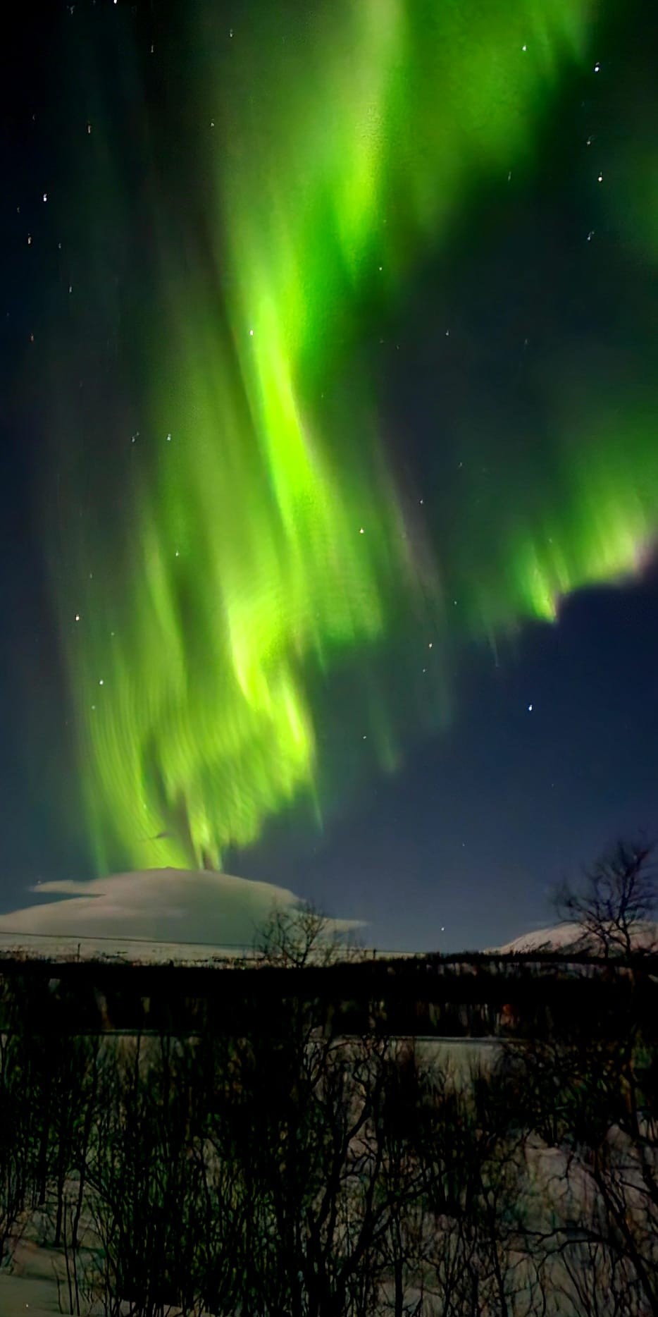 Northern Lights reflection on snow-covered landscape Kiruna